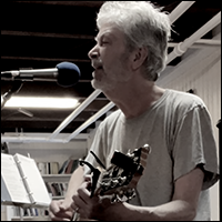 Jonathan Ochshorn playing guitar and singing